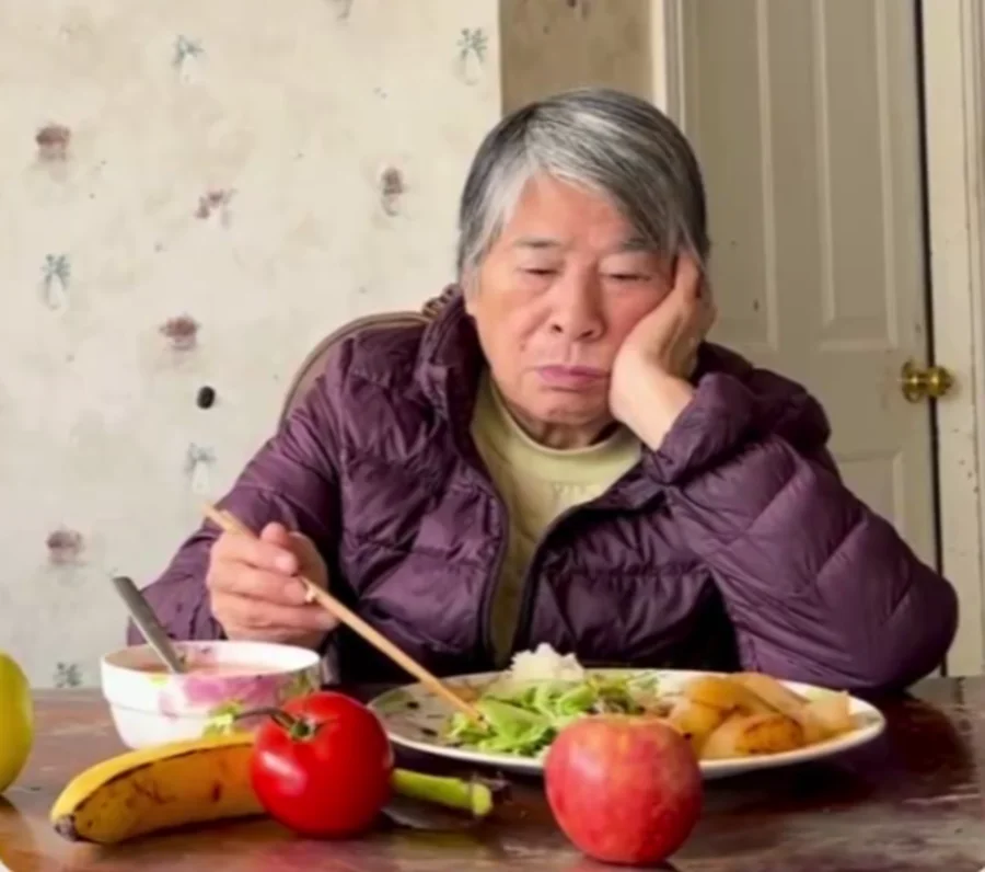 Alina's grandmother at the table with a meal, whose experience navigating a kidney-friendly diet inspired Kidney Buddy