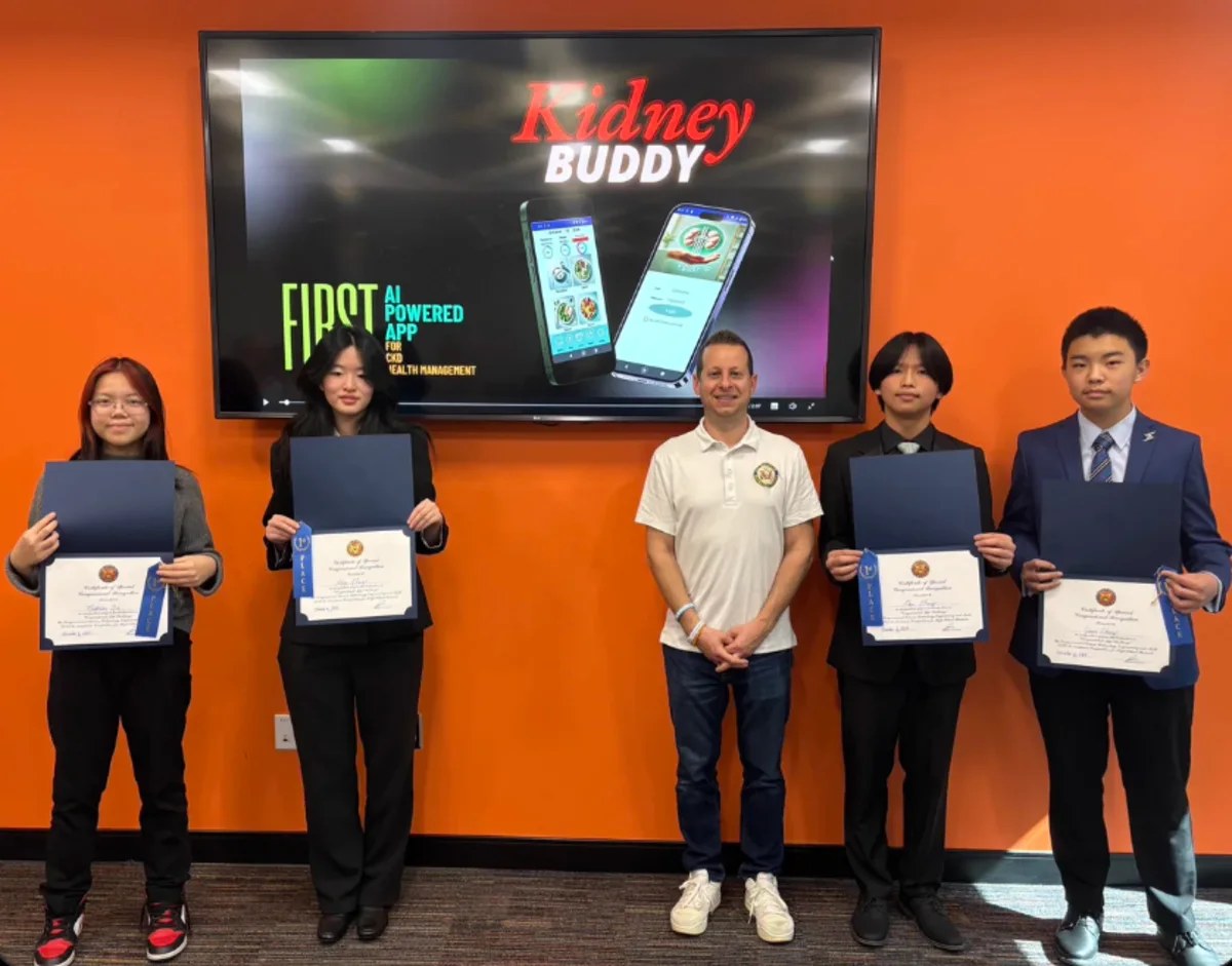 Kidney Buddy team members with certificates at an award event